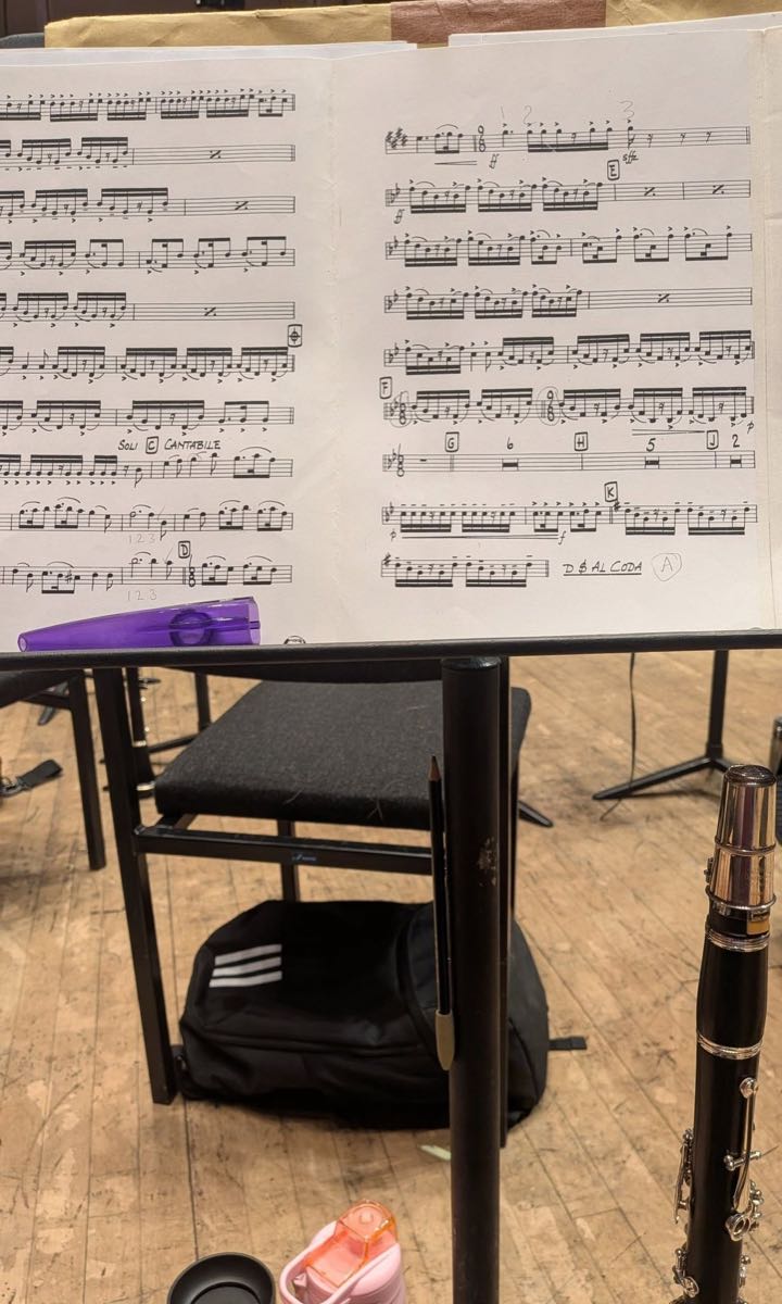 Sheet music on a stand in an orchestra rehearsal